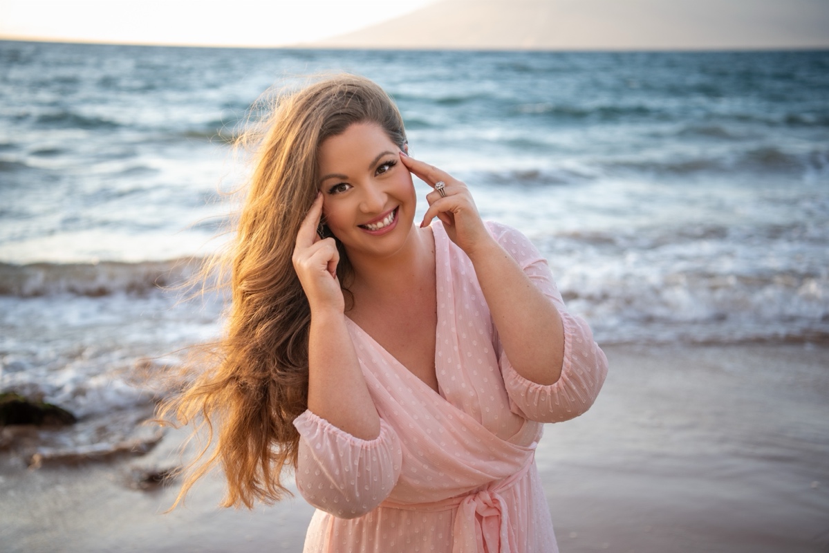 Amy McNally tapping on her temples on the beach